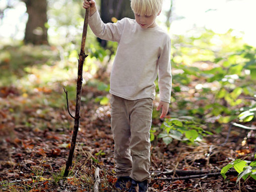 Young boy walking in the forest