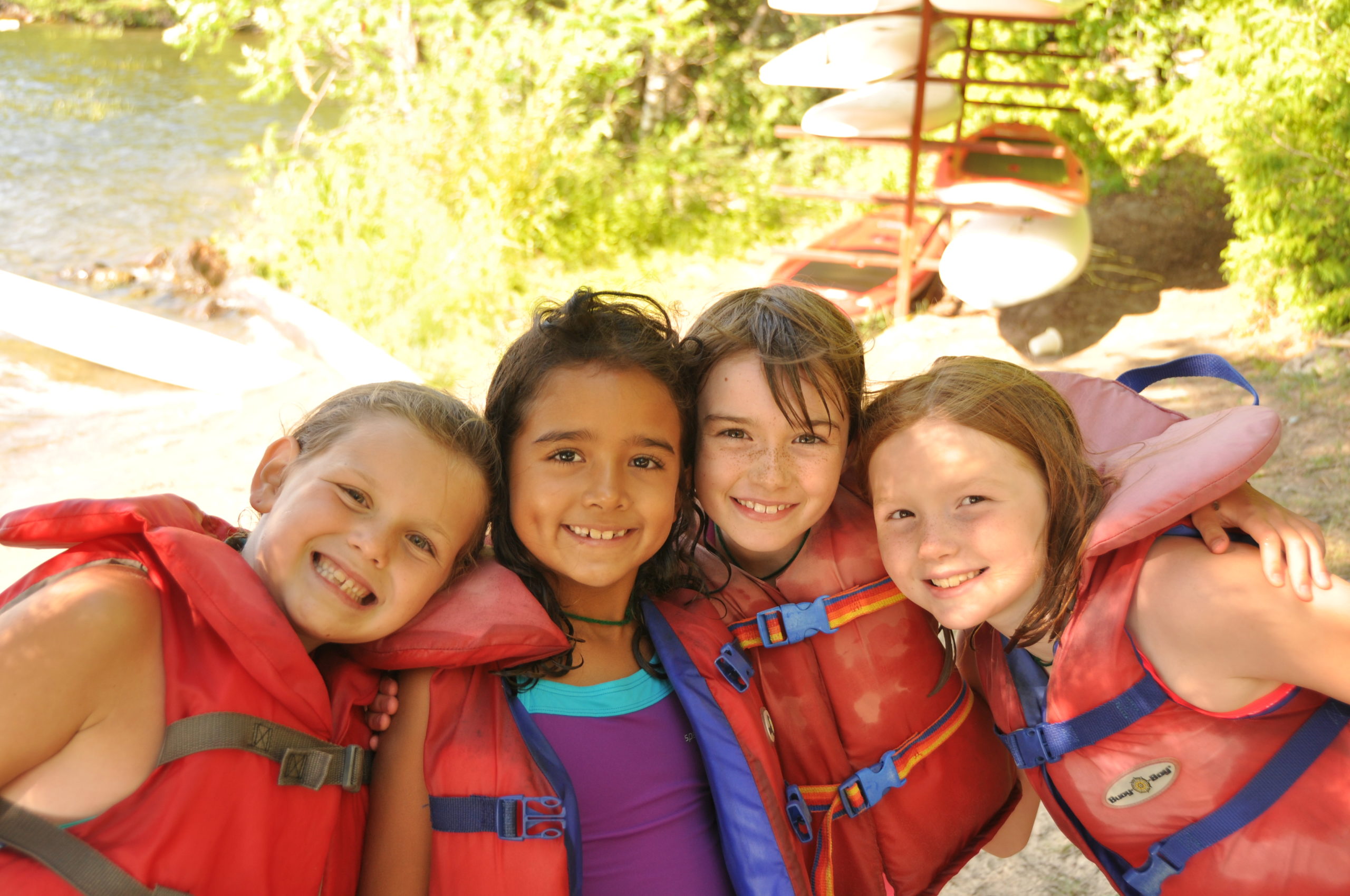 kids happy outside smiling life jackets