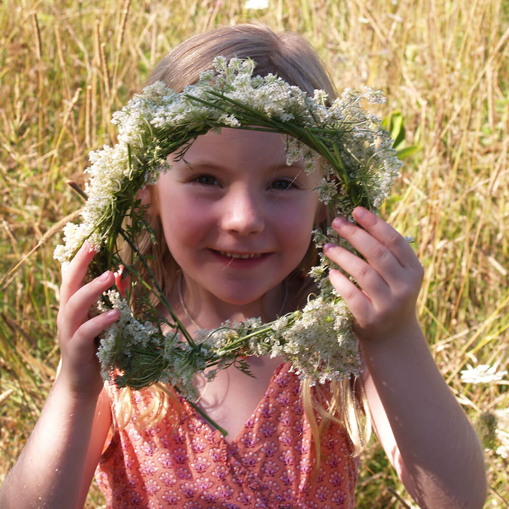 Girl outside with flower wreath
