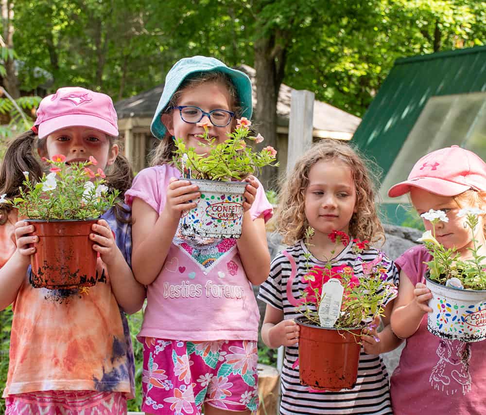 Young children holding plants 
