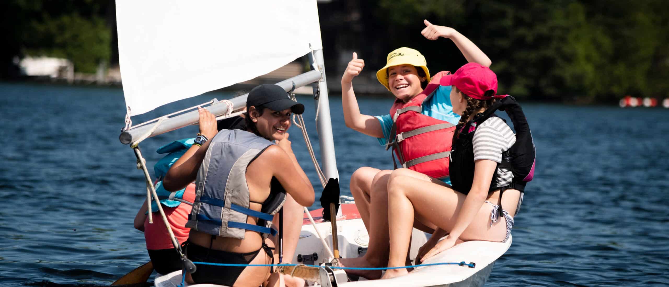 Campers smiling on sail boat