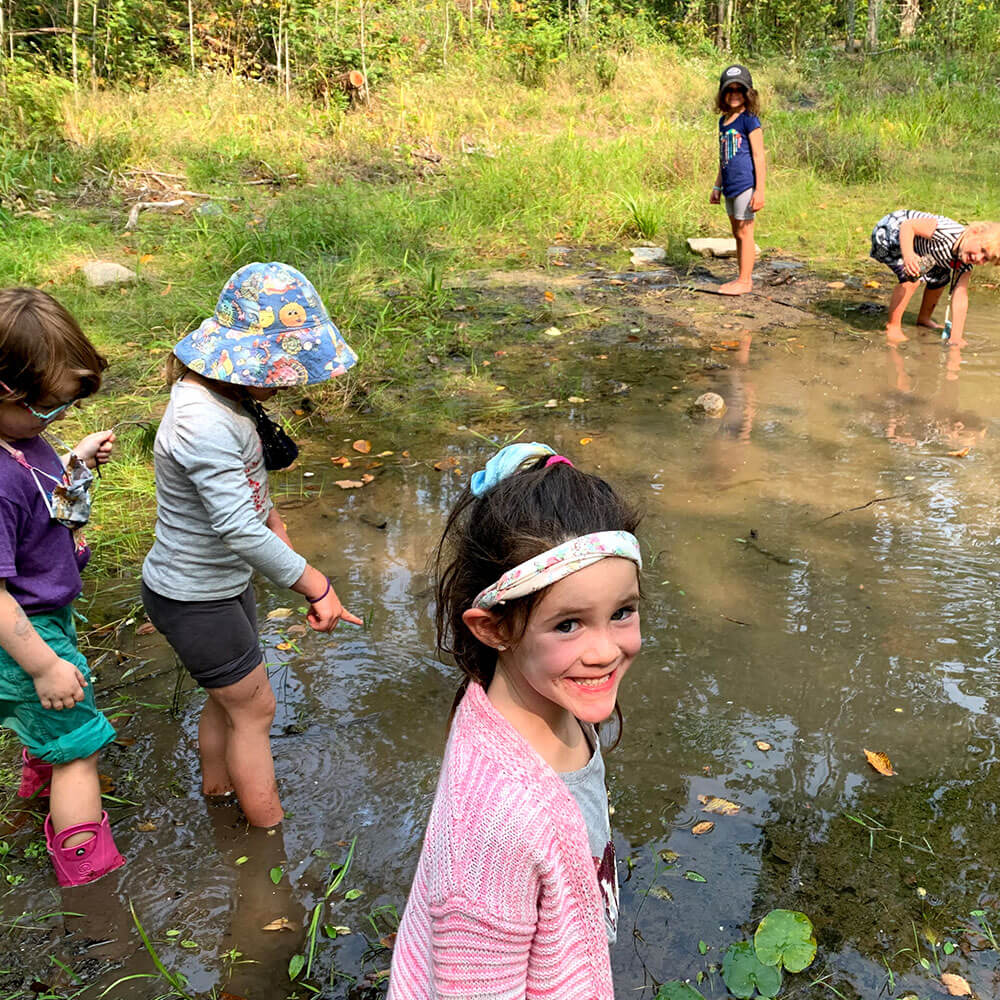 Several children in a pond learning