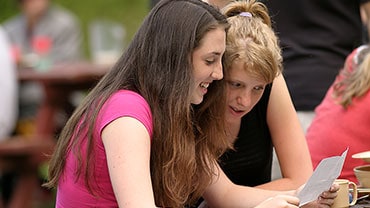 two girls reading a letter