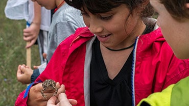 camper holding frog